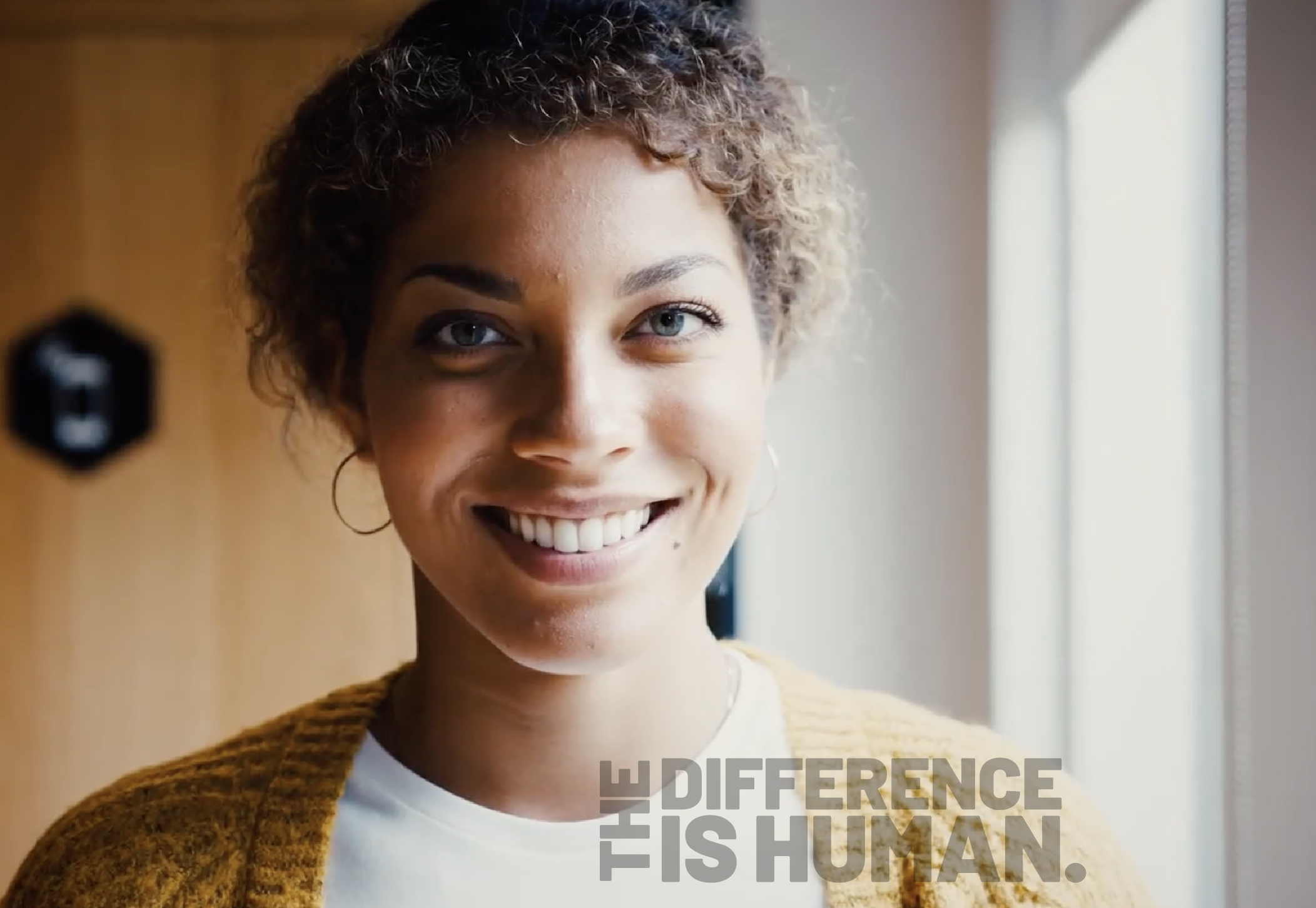 Difference is human woman smiling at camera.