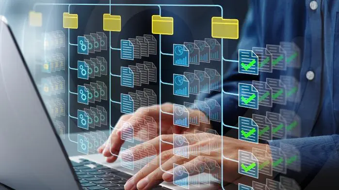 data classification hands on a laptop organizing data into folders